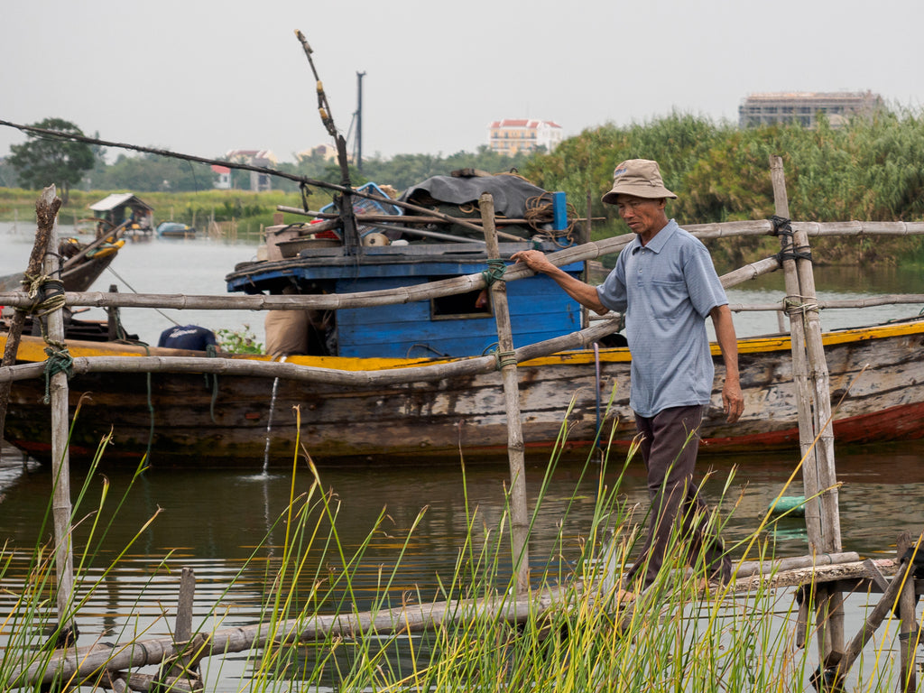 Man crossing a bridge in Hoi An Vietnam